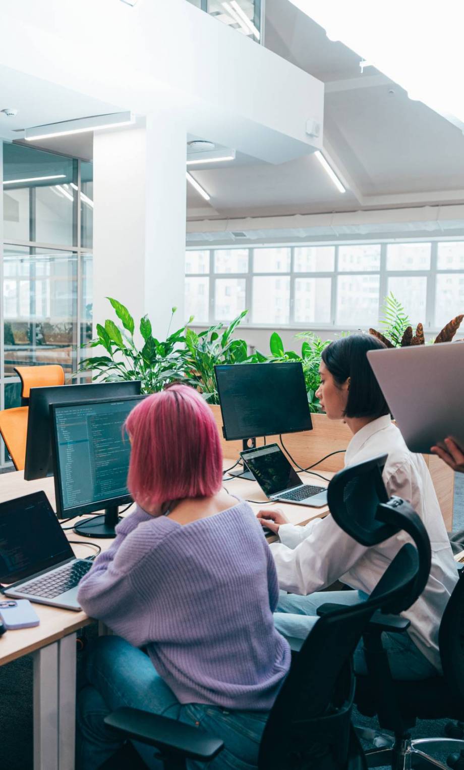 A diverse, tech-forward team collaborating in a modern workspace or remotely across screens; subtle animations, connected nodes, or digital overlays.